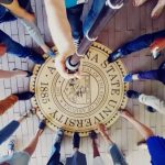 SUSI scholars' feet tapping the Arizona State University seal