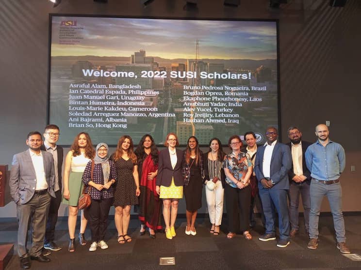 The not-late 2022 Cronkite SUSI scholar pose in front of a complete list of names