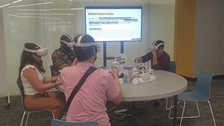 The scholars are wearing headsets as they experience virtual reality