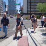 A group of scholars walk the streets of downtown Phoenix