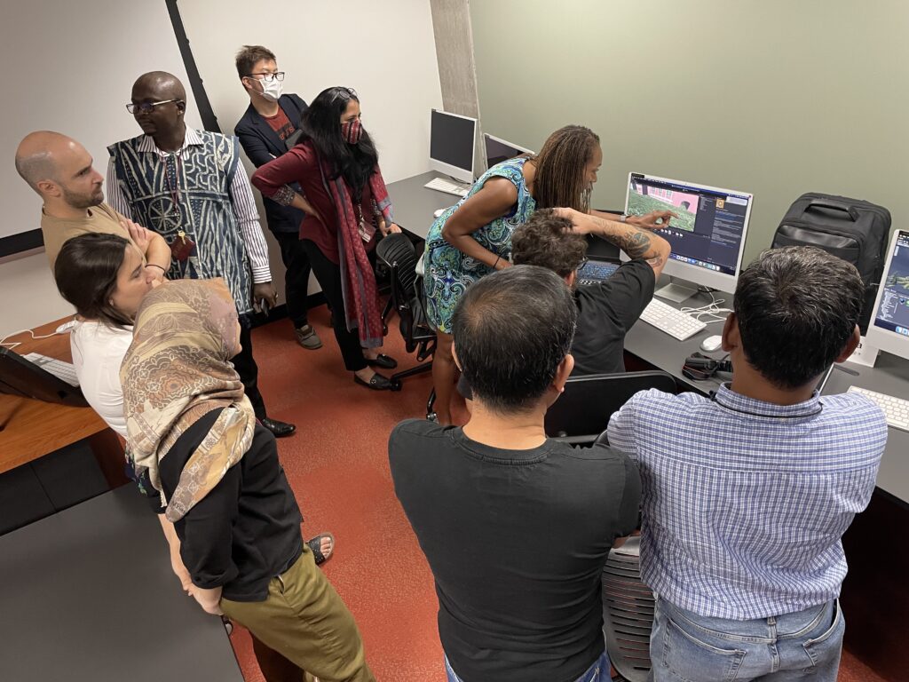 Scholars watch with trepidation as instructor Retha Hill helps Bruno Nogueira (Brazil) remedy a problem with his design