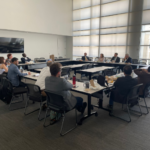 The scholars are seated in a roundtable setting for discussion with federal judges at the U.S. District Court in Phoenix, Arizona