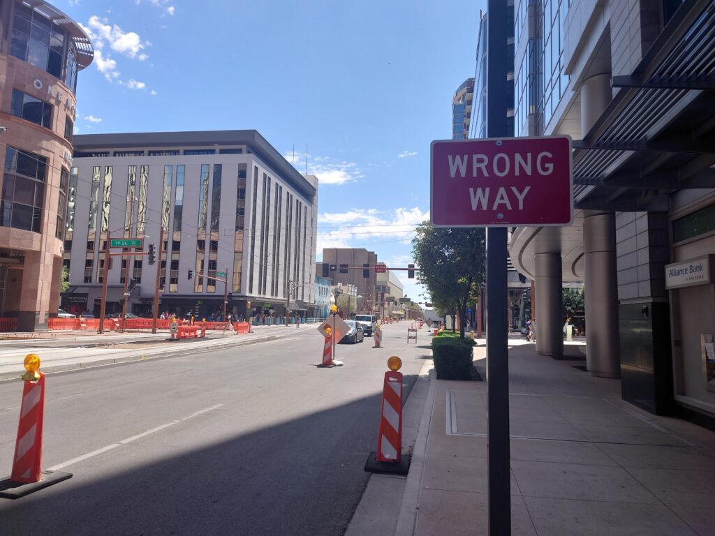 Traffic cones, a construction zone, and a Wrong Way sign