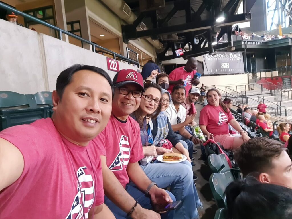 SUSI Scholars in the stands, enjoying ballpark food and waiting for the game to start