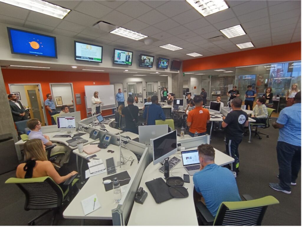 A wide shot of the interior of the Cronkite Sports Bureau, where Scholars attended the news meeting