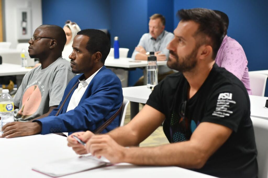 The scholars listen attentively while Arizona Republic staff explain how their newsroom operates