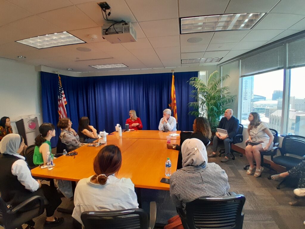 The scholars sit around a conference table in Mayor Kate Gallego's office