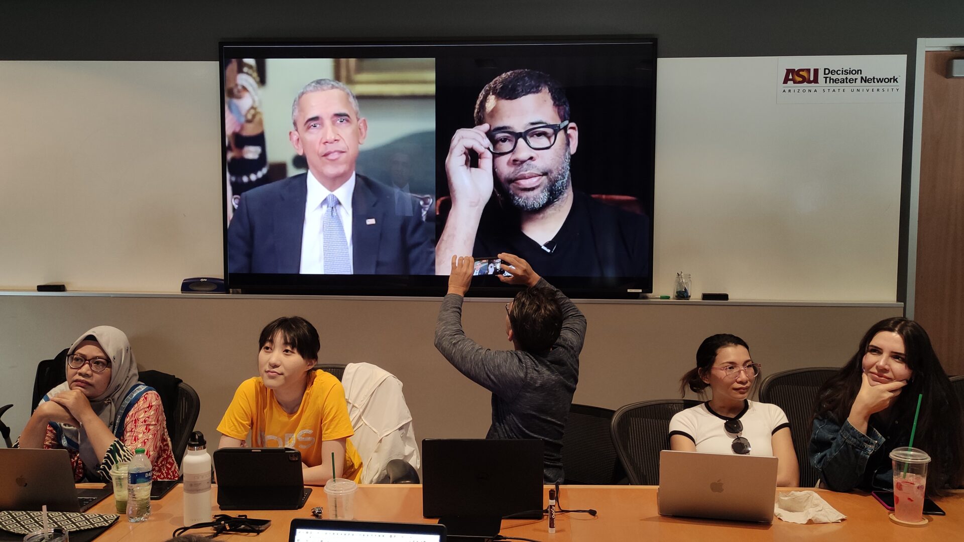 The scholars watch a video by Jordan Peele with a deepfake of former President Obama