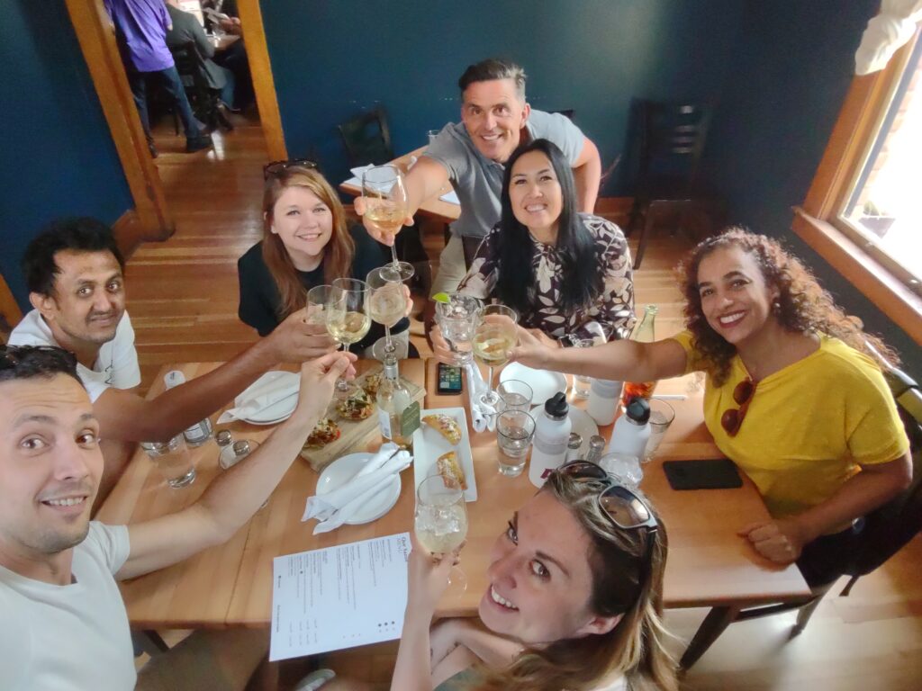 A group selfie of scholars sitting around a local restaurant table