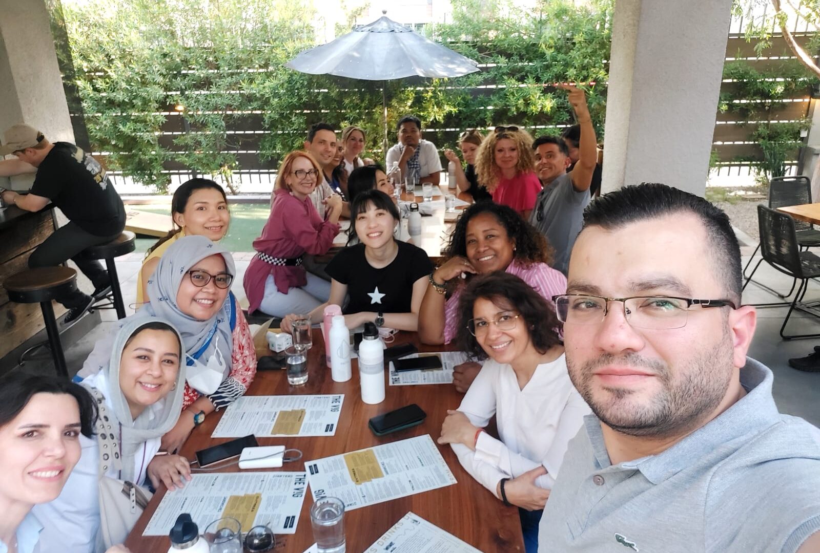 The scholars, program staff, and community members smile for one of their first group selfies