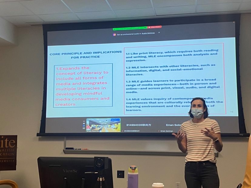 Dr. Kristy Roschke stands in front of the projection screen in 444