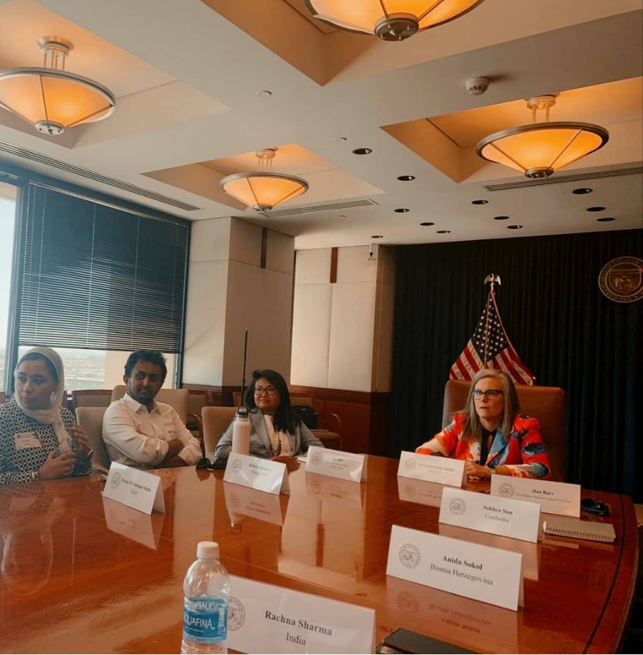 The scholars are pictured at a table headed by Governor Hobbs