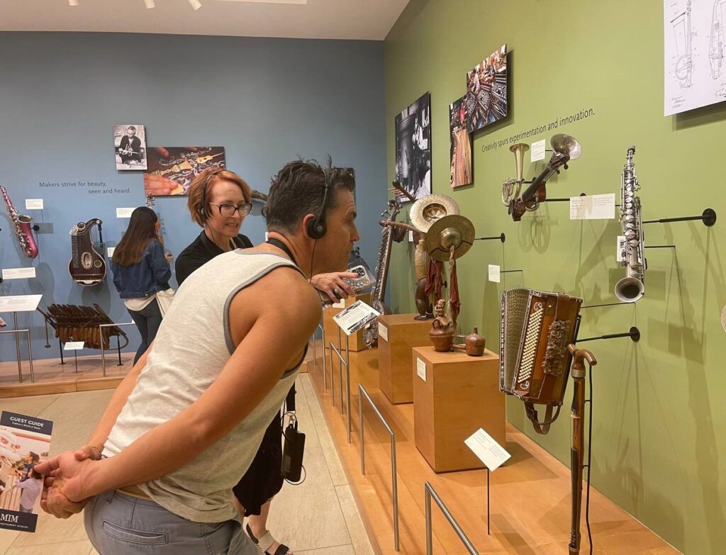 Examining various instruments on display at the MIM