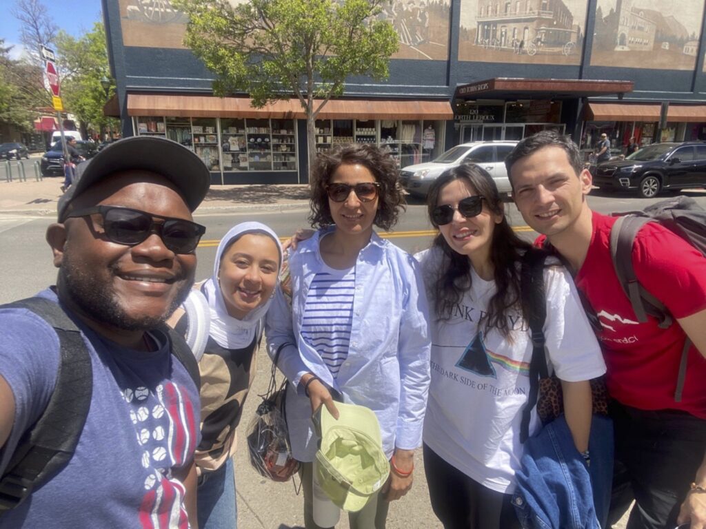 A group of scholars smiles into the camera in downtown Flagstaff