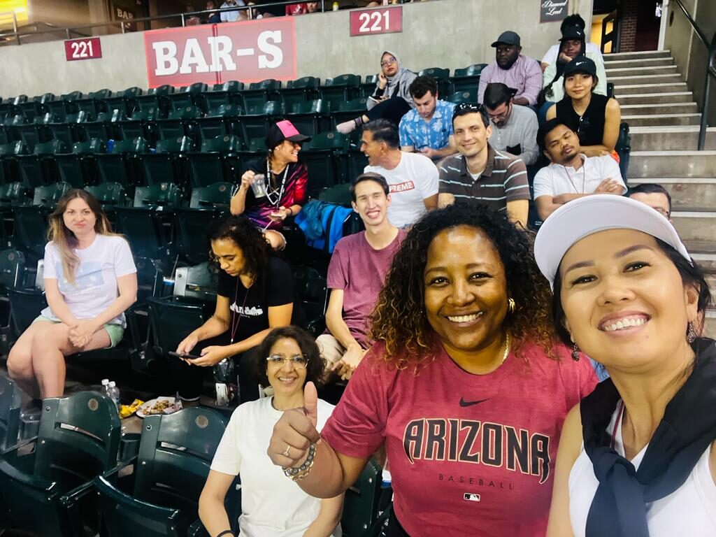 The scholars sit in the all-you-can-eat section of Chase Field, taking a group selfie