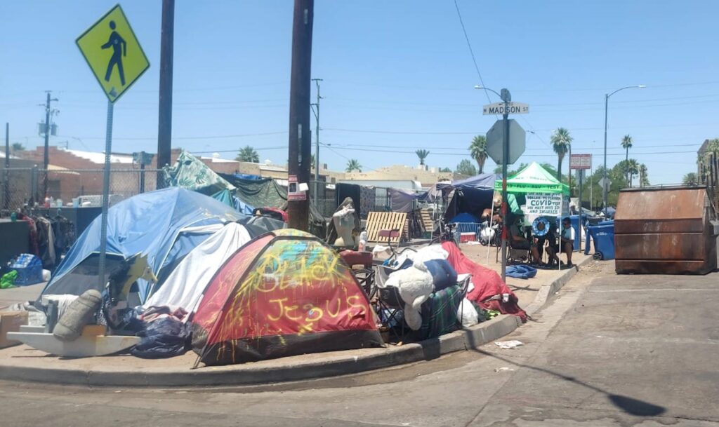 Tents and makeshift shelters crowd the sidewalks and streets