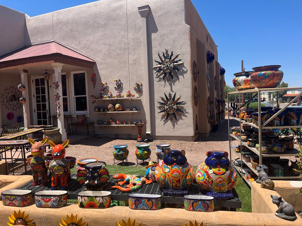 Colorful pottery and metal decorative items on display in Tubac, AZ