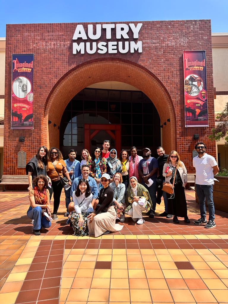 All of the scholars pose for a group photo in front of the Autry Museum of the American West