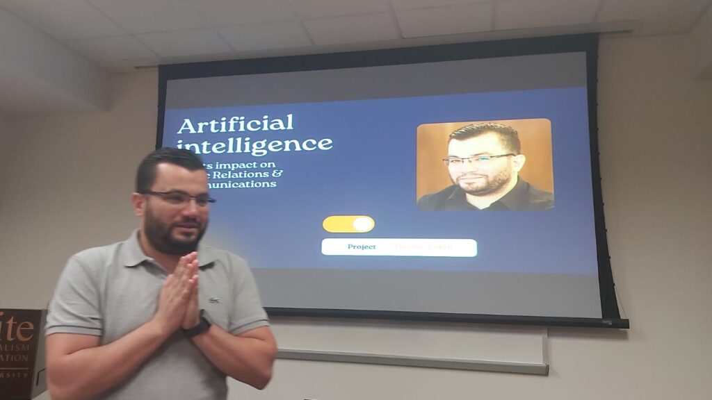 A scholar in front of a slide presentation