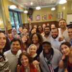 The Scholars pose for a group selfie at Busboys & Poets restaurant in Washington, D.C.