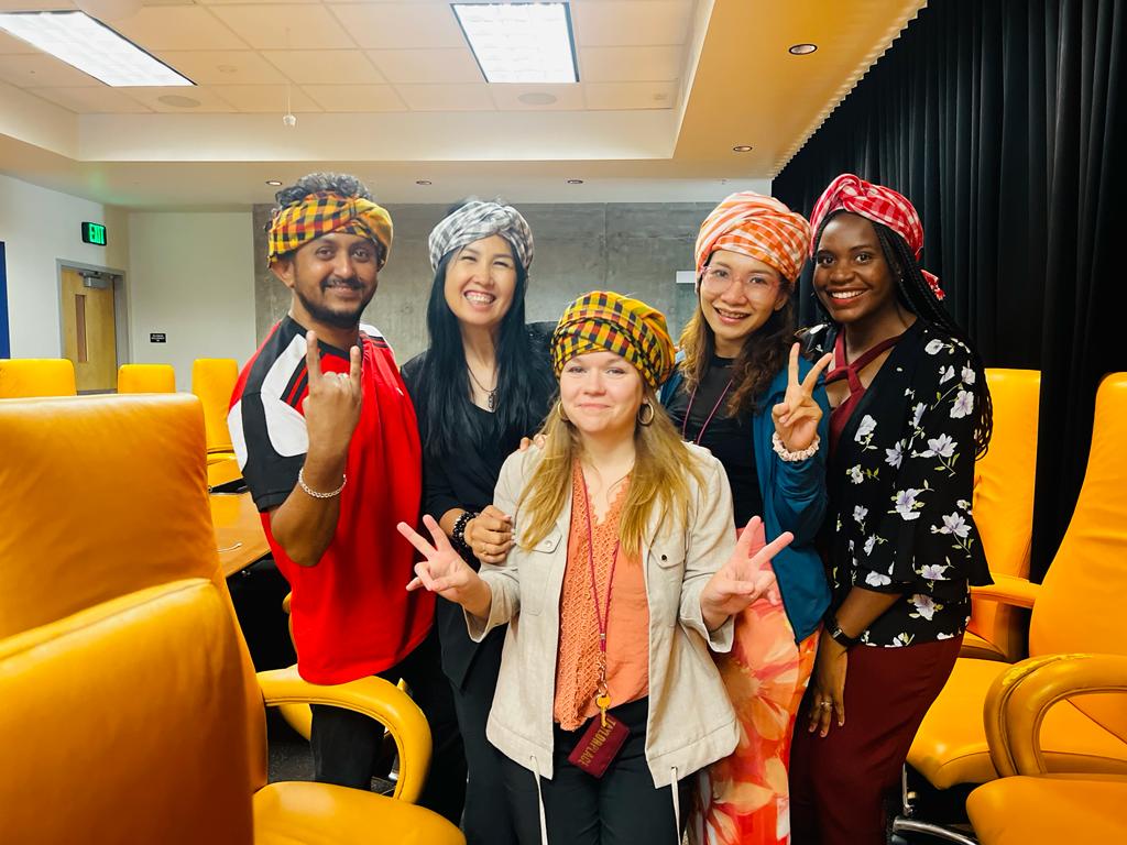 A group of scholars posed wearing Cambodian headscarves