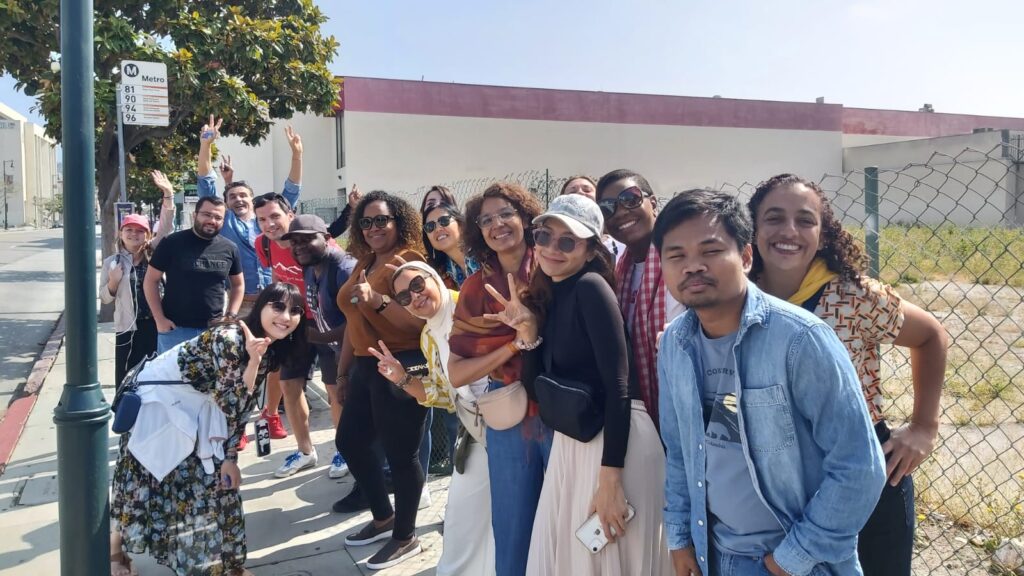 The scholars stand at a bust stop in metro Los Angeles