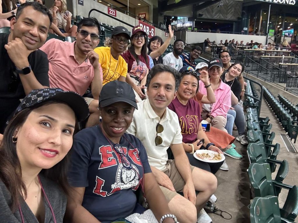 The scholars smile at the camera from the bleachers at Chase Field