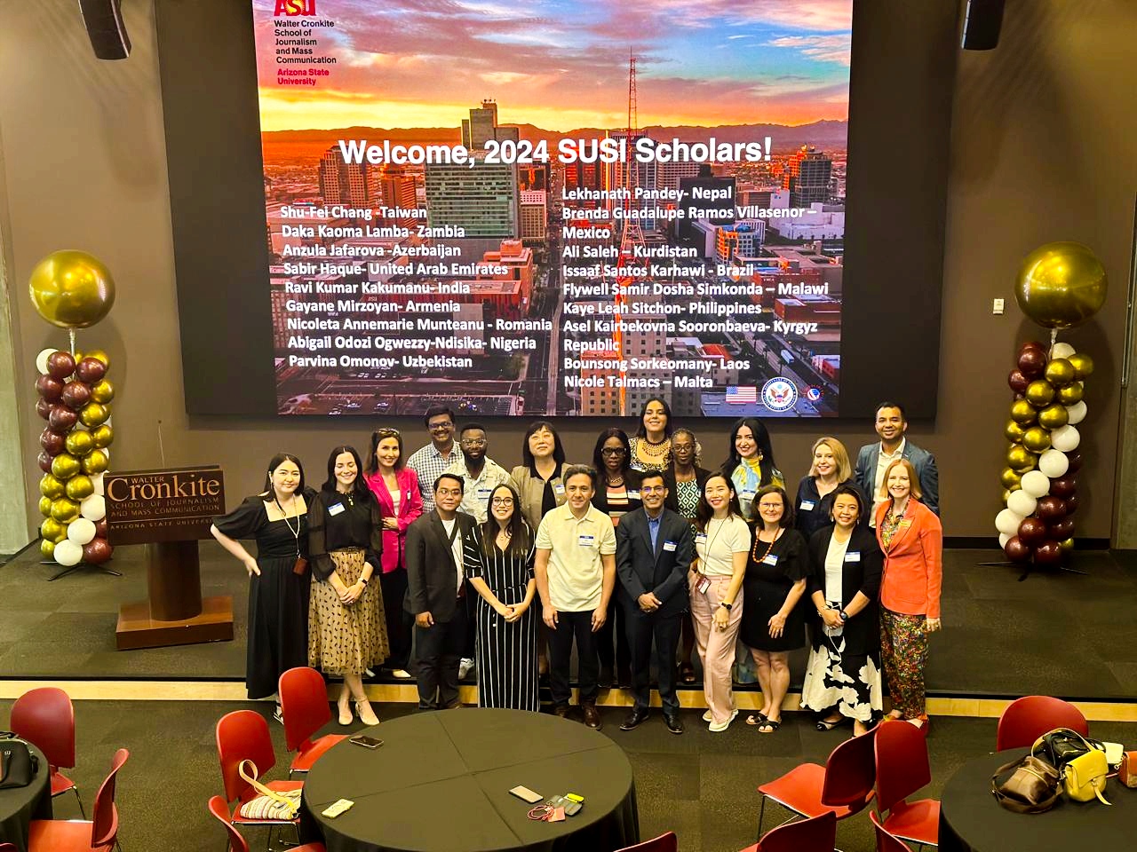 The scholars pose in the First Amendment Forum of the Cronkite School set up for their Welcome Reception