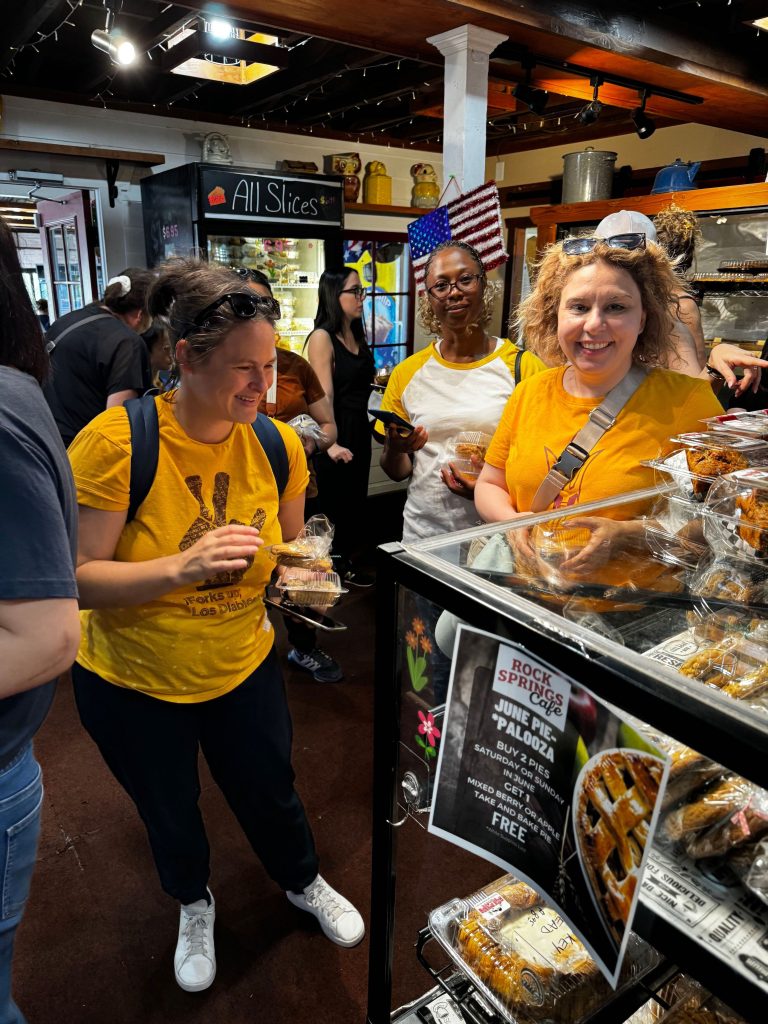 Smiling scholars examine the baked goods on display at the historic Rock Springs Cafe in Arizona